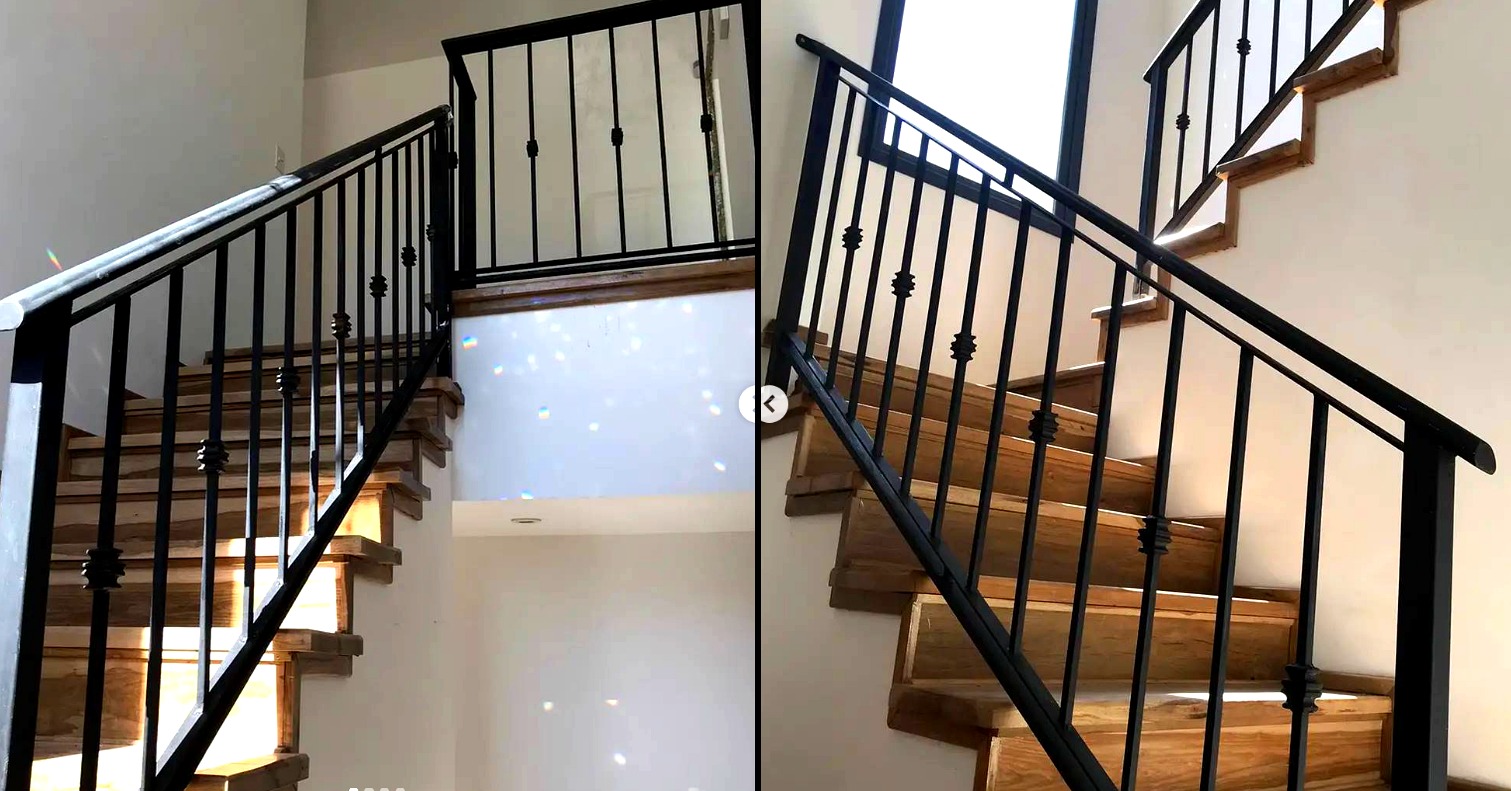Baranda escalera hierro negro con detalles forjados y madera
